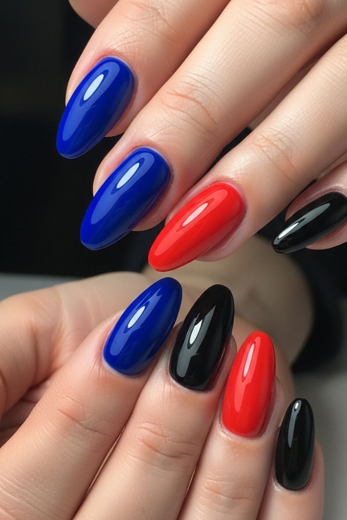 Red, royal blue, and black dip powder nails, glossy finish