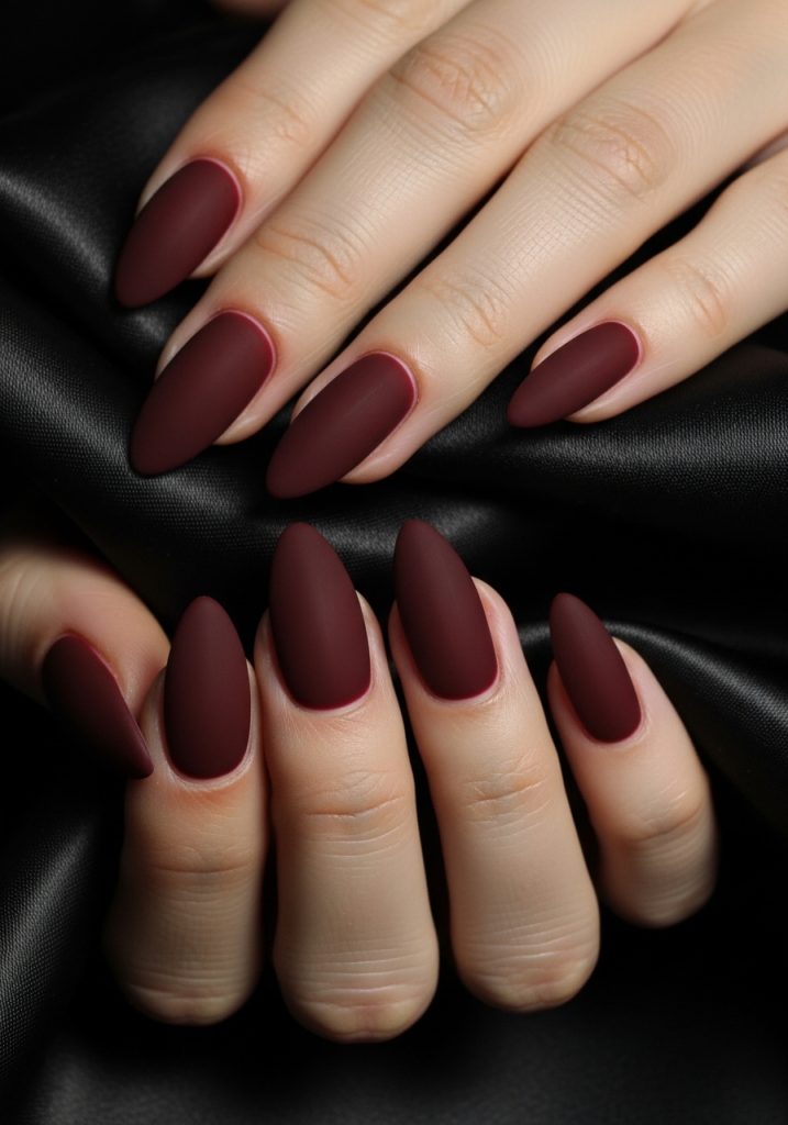  Medium almond nails in dark cherry red matte velvet finish for a moody glamorous prom look
