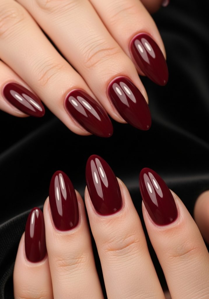  Medium almond shaped deep burgundy wine red glossy prom nails on black velvet
