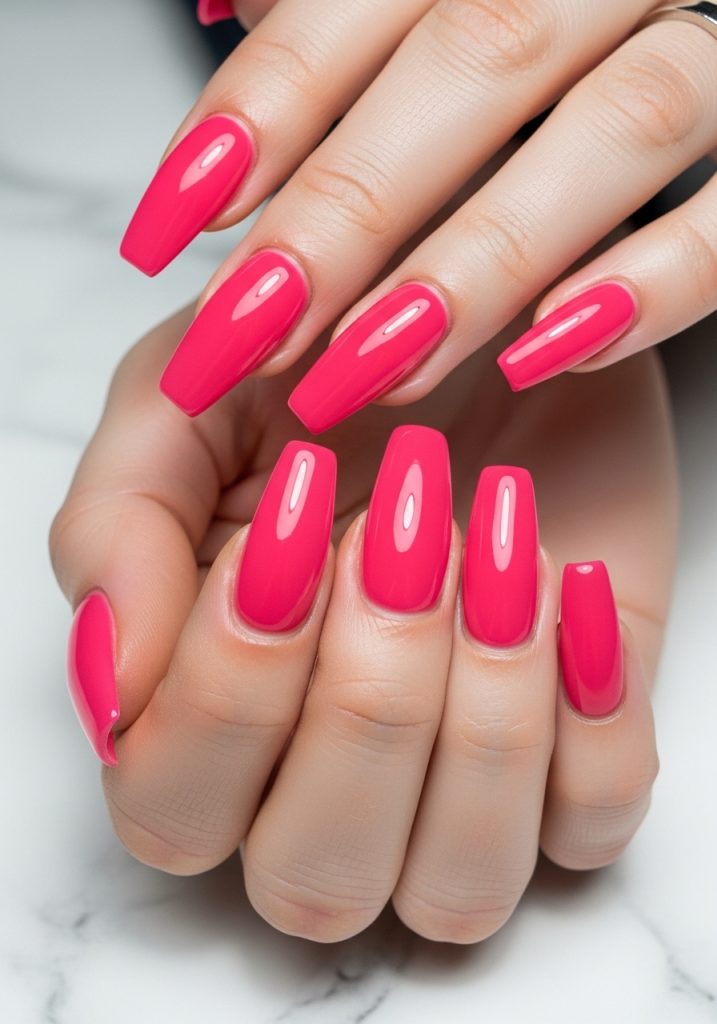  Long coffin shaped vibrant hot pink glossy prom nails against white marble