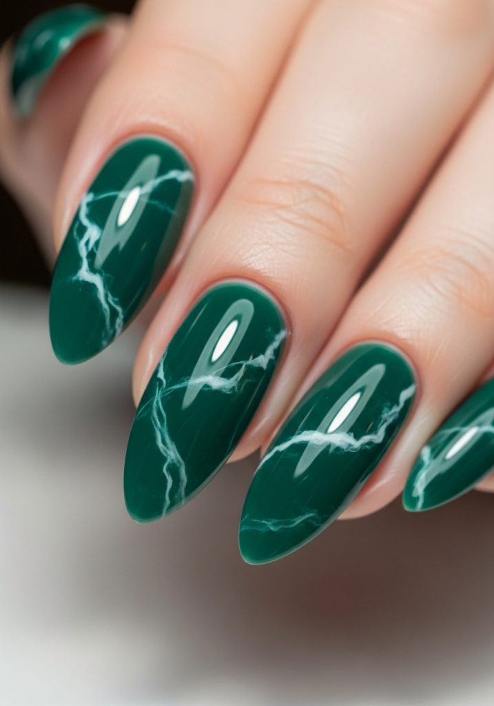 Jade green nails with white marble vein pattern and high gloss finish