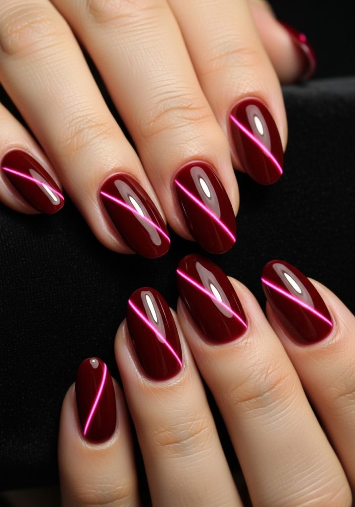 Medium oval shaped deep red magnetic cat eye gel prom nails with dramatic light catching streak