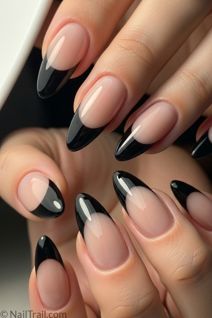 Almond-shaped black French tip gel nails with glossy finish