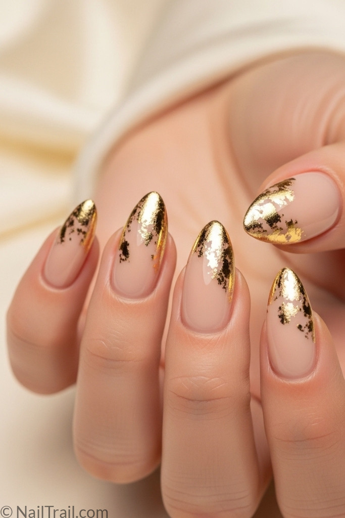 Beige almond nails with gold foil accents