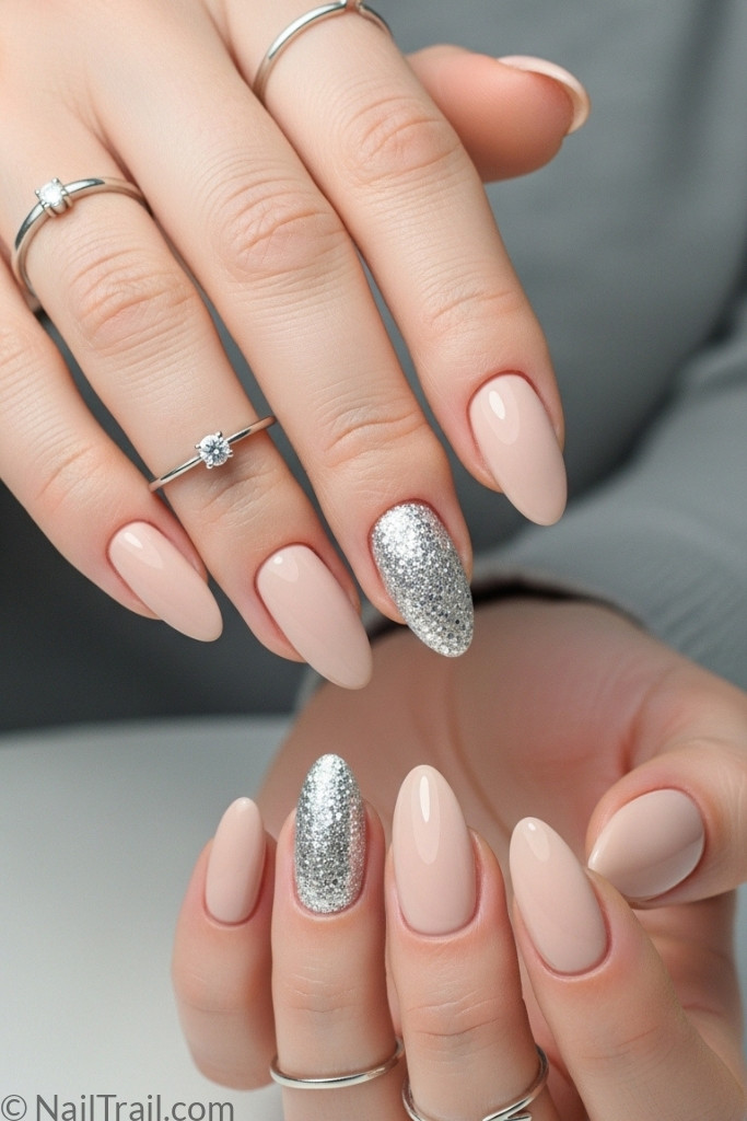 Glitter accent nail design with nude manicure