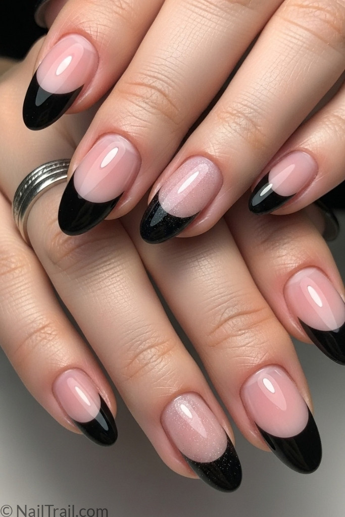 Glossy classy black French tip nails with subtle shimmer on medium-length oval nails