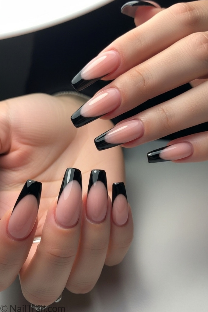 Long coffin-shaped black French tip acrylic nails with glossy finish