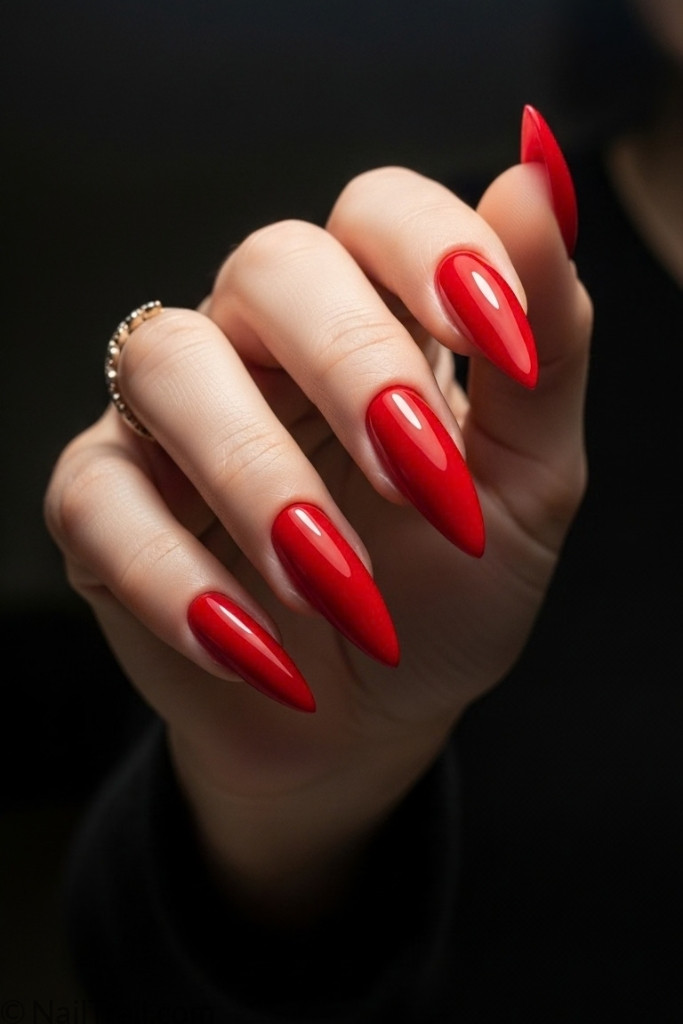 Long stiletto nail shape with red polish