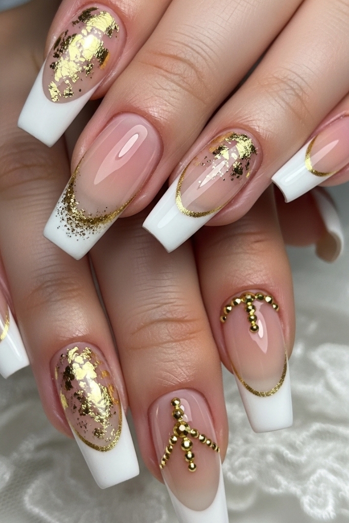 Luxury French manicure acrylic nails with gold accents and white tips