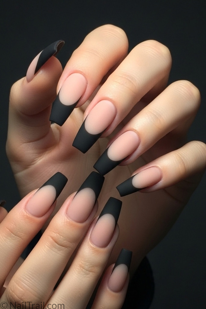 Matte black French tip nails on long coffin-shaped nails with nude base