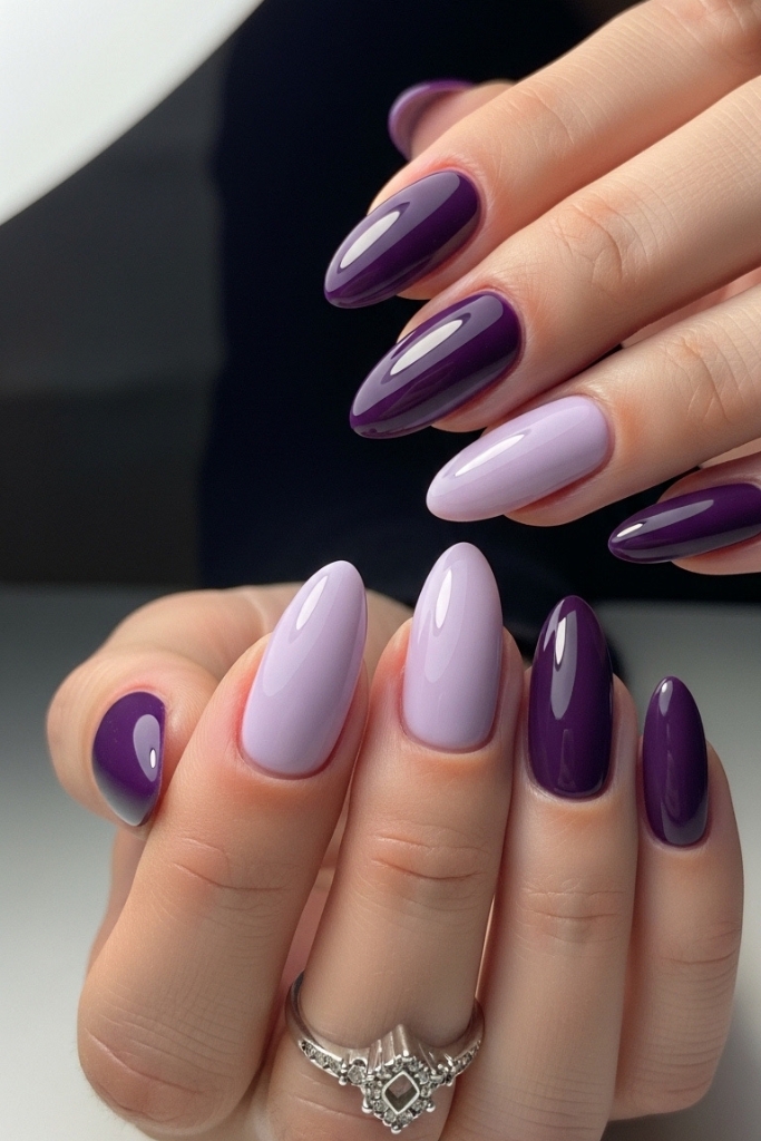 Medium-length purple nails with alternating shades for a stylish look