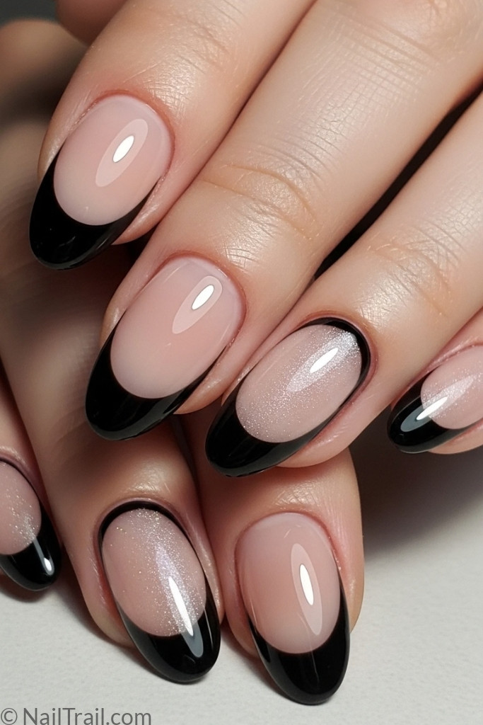 Oval-shaped black French tip nails with nude base