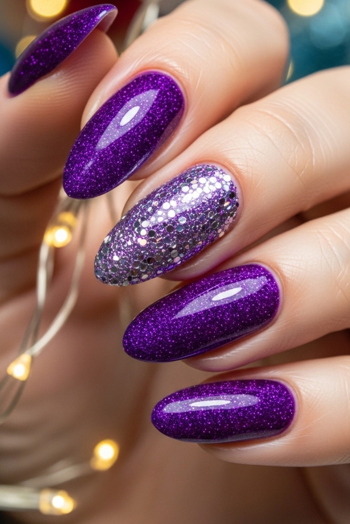 Purple glitter manicure with accent nail for festive look