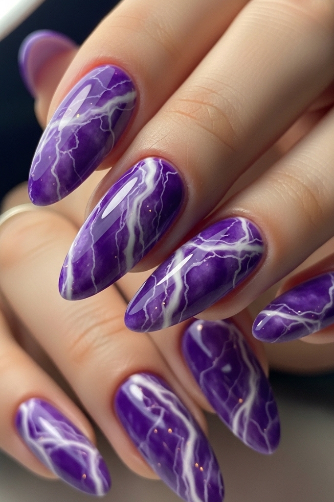 Purple marble nail design with white and lavender veins
