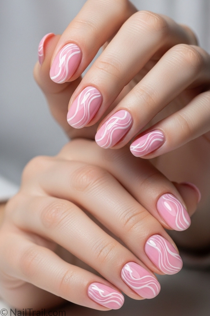 Short pink nails with swirl nail art