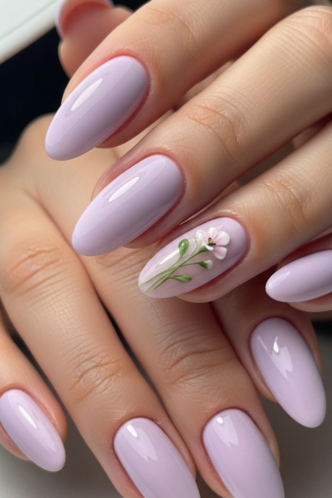 Soft lavender nails with a glossy finish and subtle floral accent