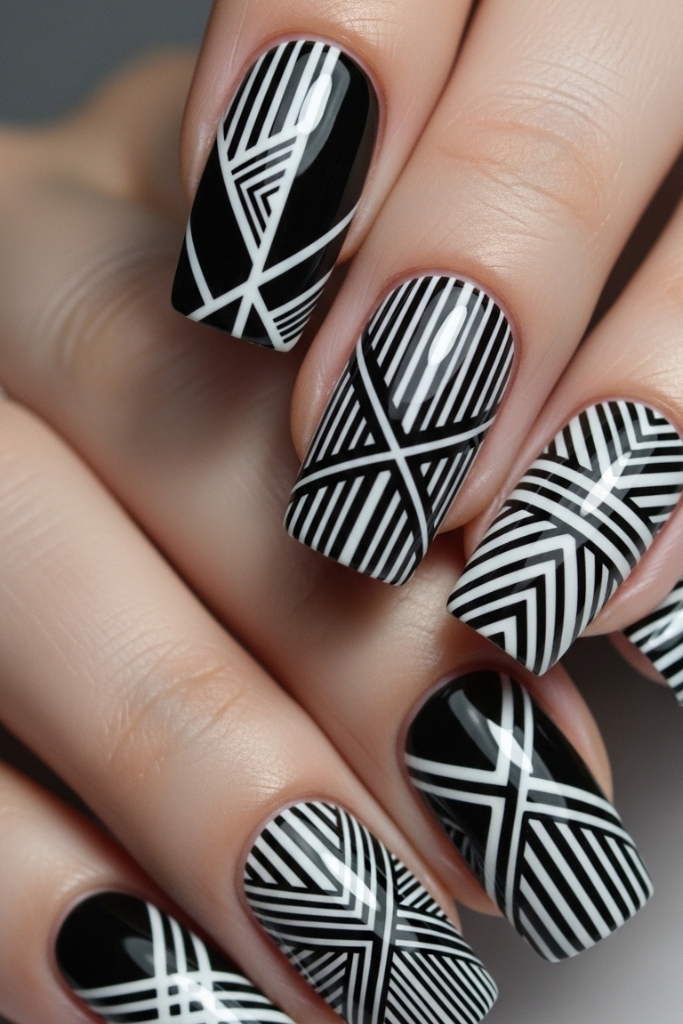 Monochrome geometric nail art with triangles and stripes, modern and stylish design