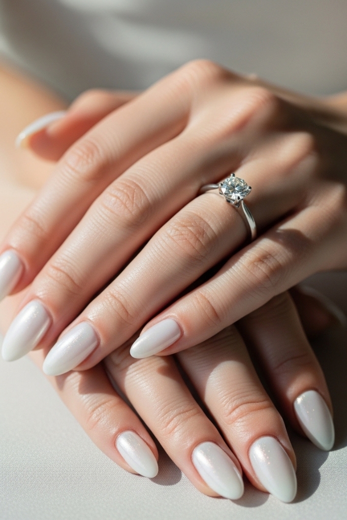 Pearl white engagement nails with subtle shimmer