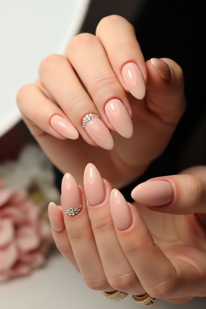 Nude almond nail set with rhinestone accents