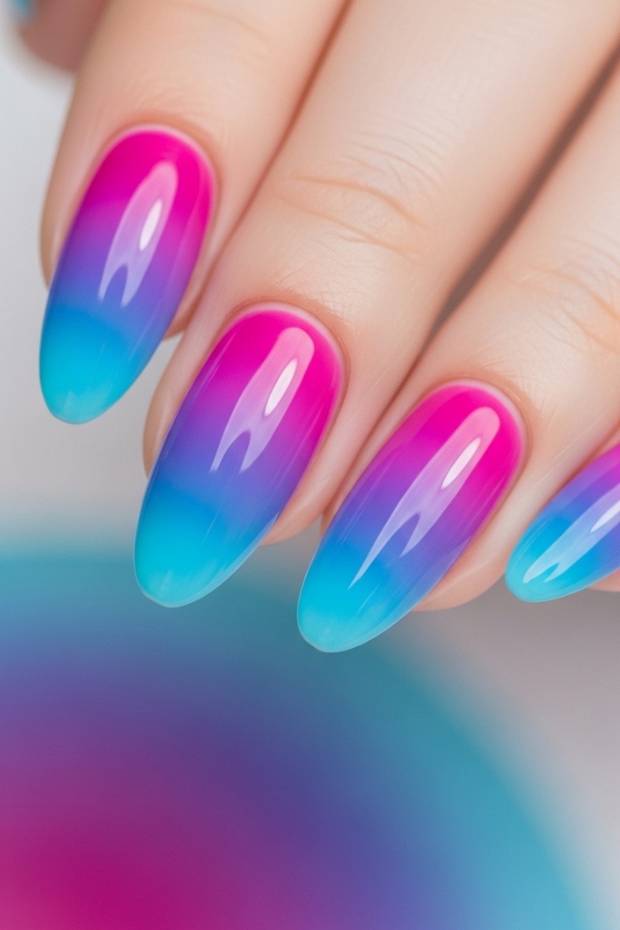Colorful ombre nails blending pink, purple, and blue, artistic and vibrant design