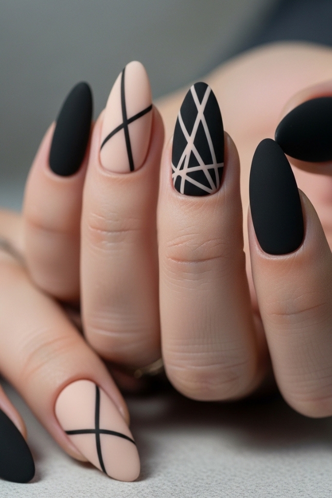 Chic matte nails with nude and black geometric accents, modern minimalist design