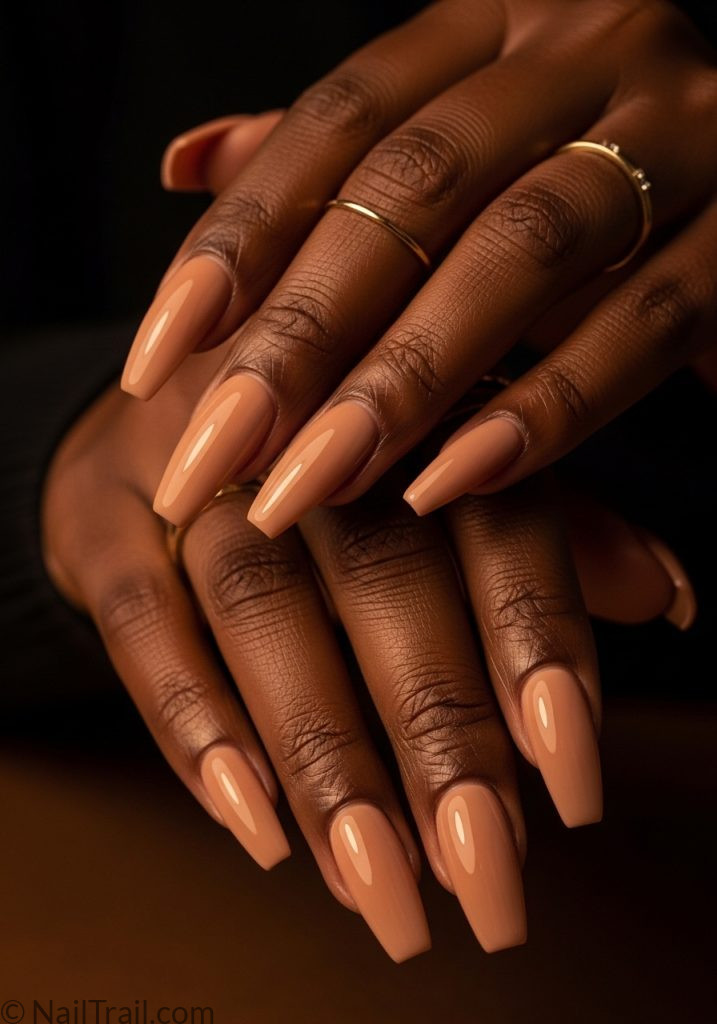 Deep brown hands with glossy nude coffin nails easy summer nails coffin simple almond