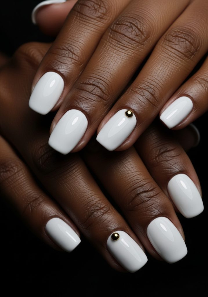 White chrome short oval nails on dark brown hands with black background