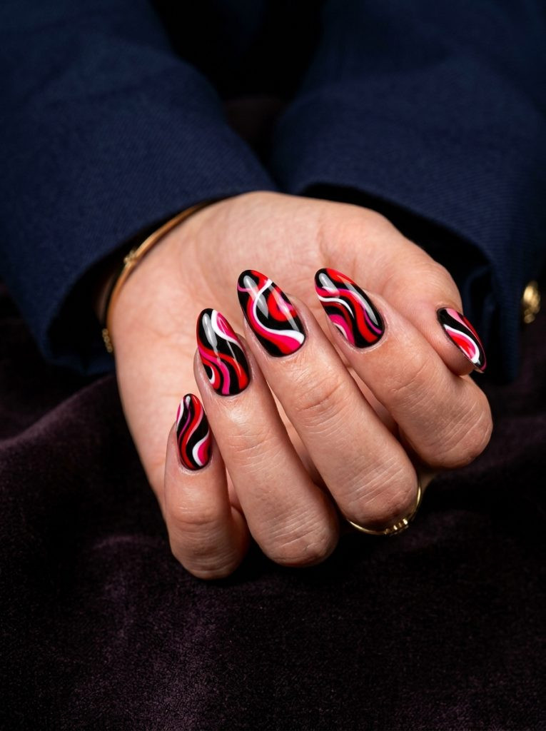red pucci nails scarlet pink white swirl black base almond bold glossy 2026