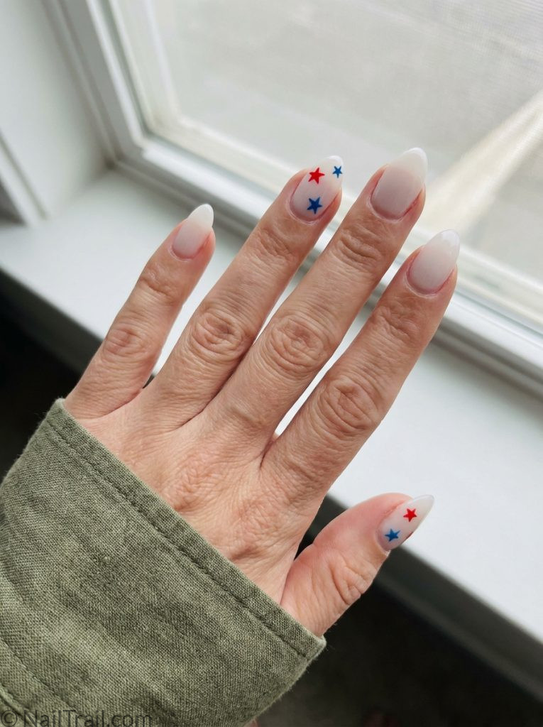 subtle 4th of july nails sheer white tiny stars accent almond glossy