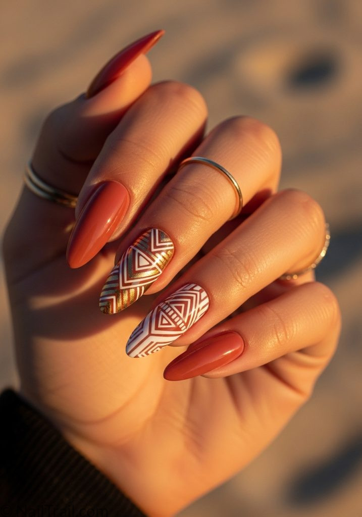 Medium tan hand with terracotta almond nails gold geometric art coachella nails almond ideas