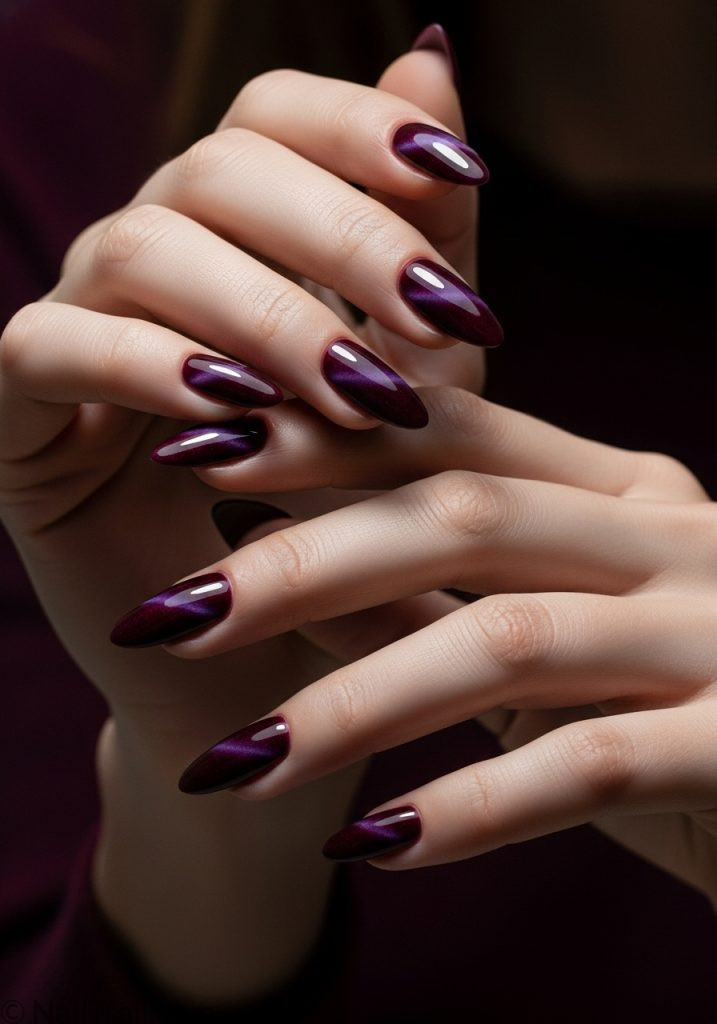 Medium fair hands with burgundy almond nails dark red purple cat eye shimmer burgundy cat eye nails