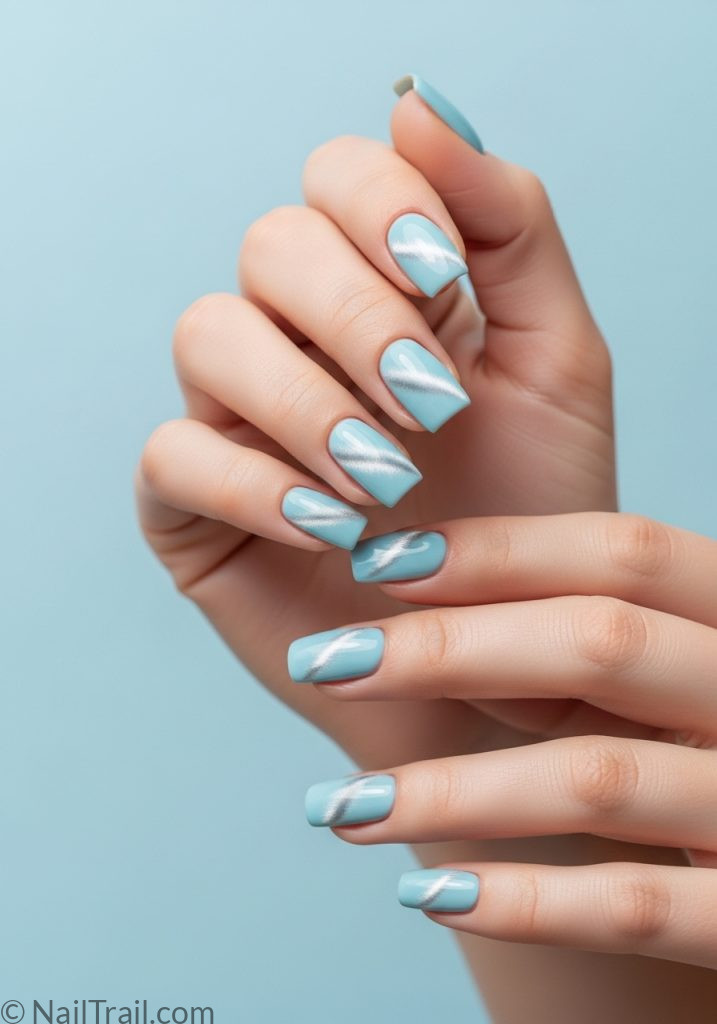 Fair neutral hands with light blue square nails silver cat eye shimmer light blue cat eye nails design