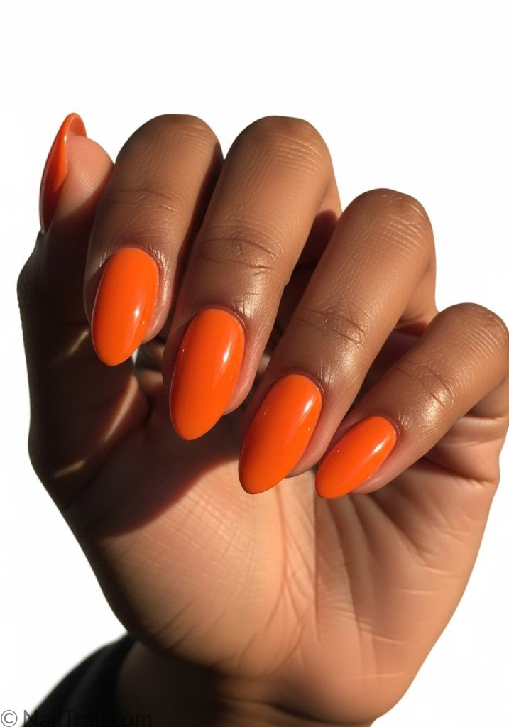 Dark brown hand with tangerine orange short almond nails cute short summer nails orange almond