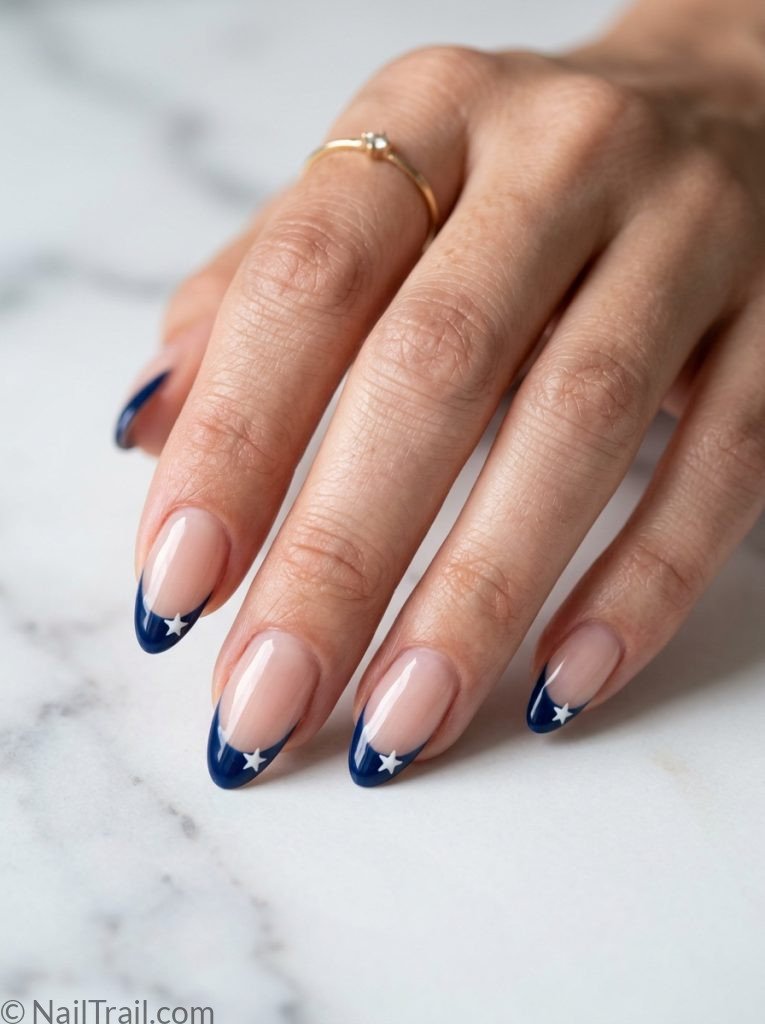simple patriotic nails french tip almond navy blue sheer base white star tip center glossy elegant