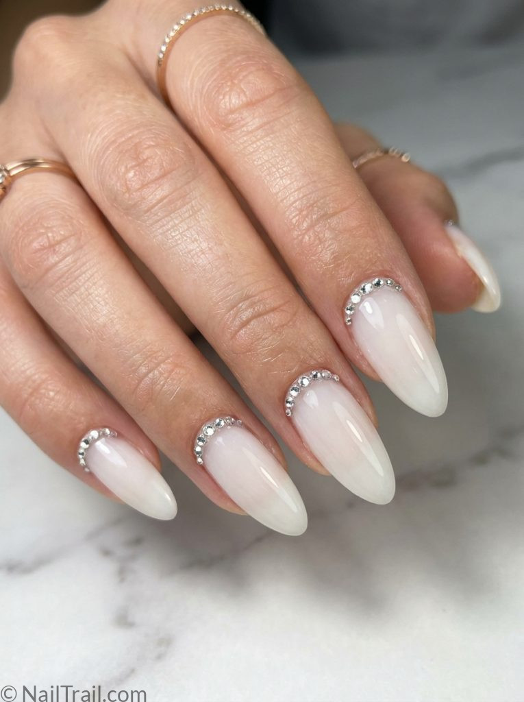 milky white nails rhinestones cuticle line almond bridal elegant luxurious romantic glossy