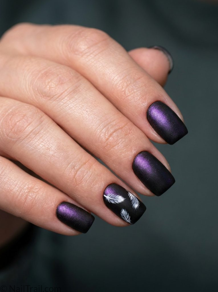 bts nails short square shape matte black iridescent purple shimmer white feather detail dark moody background