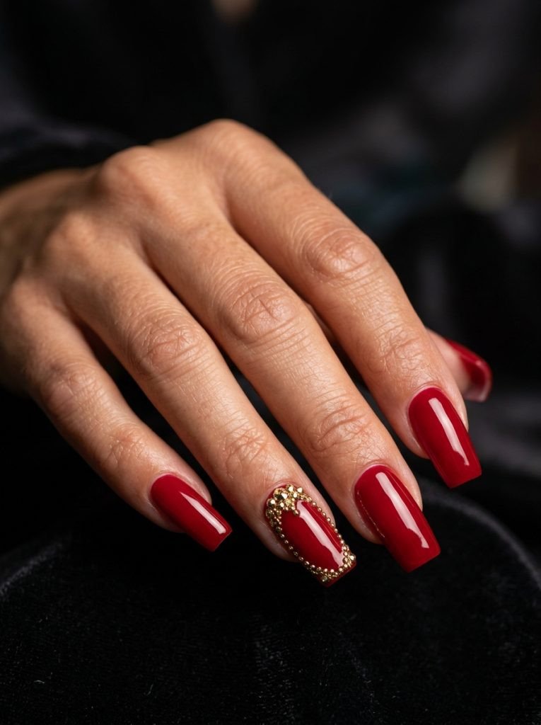 2000s square nails long square shape bold red gold rhinestone accents glossy gel finish dark moody background